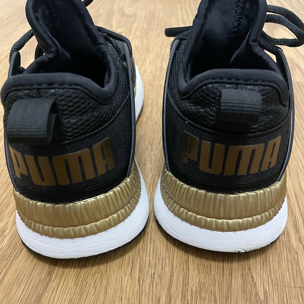 Puma black and gold sneakers